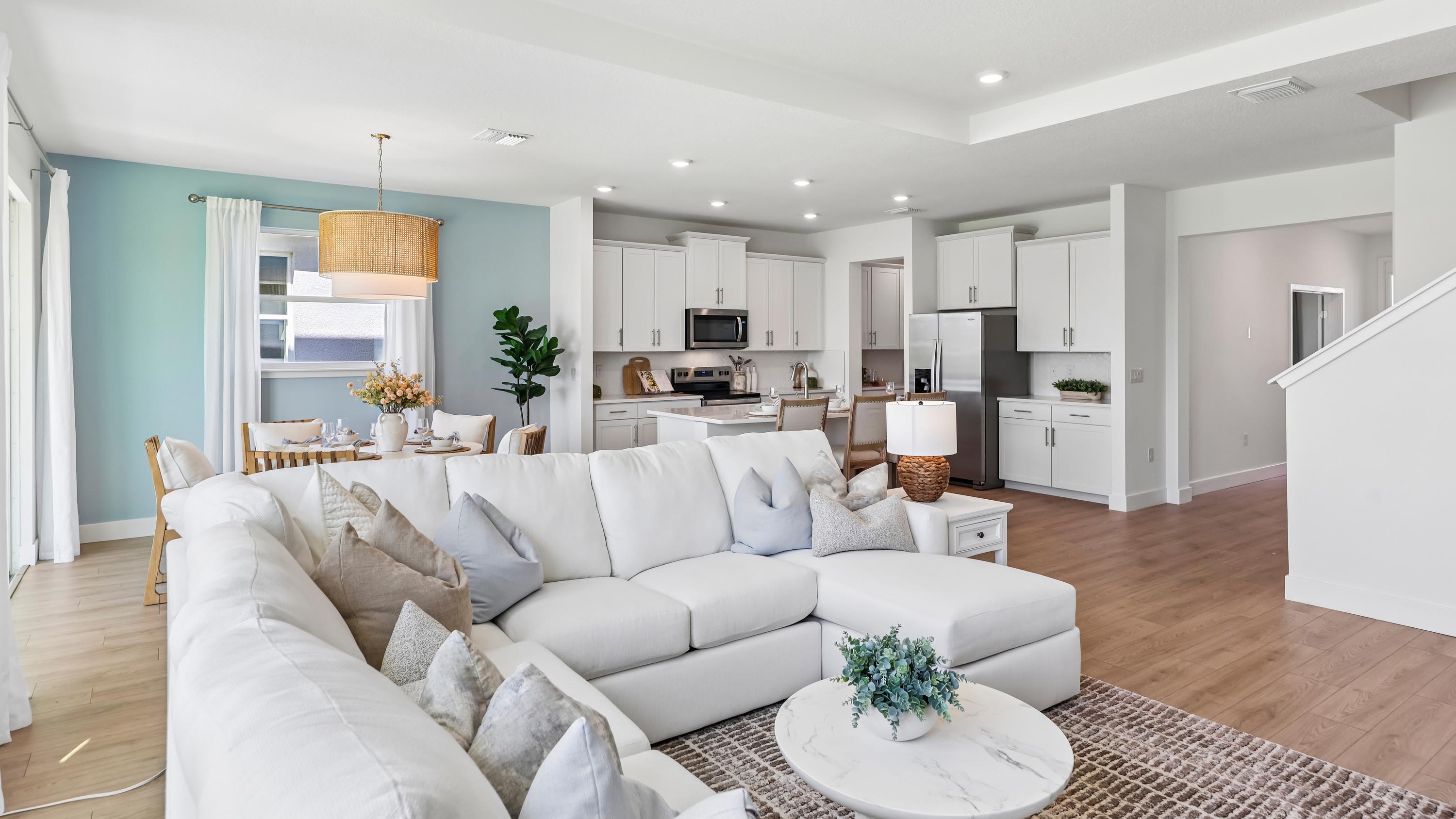 Holden model living area opening to the kitchen and dining room