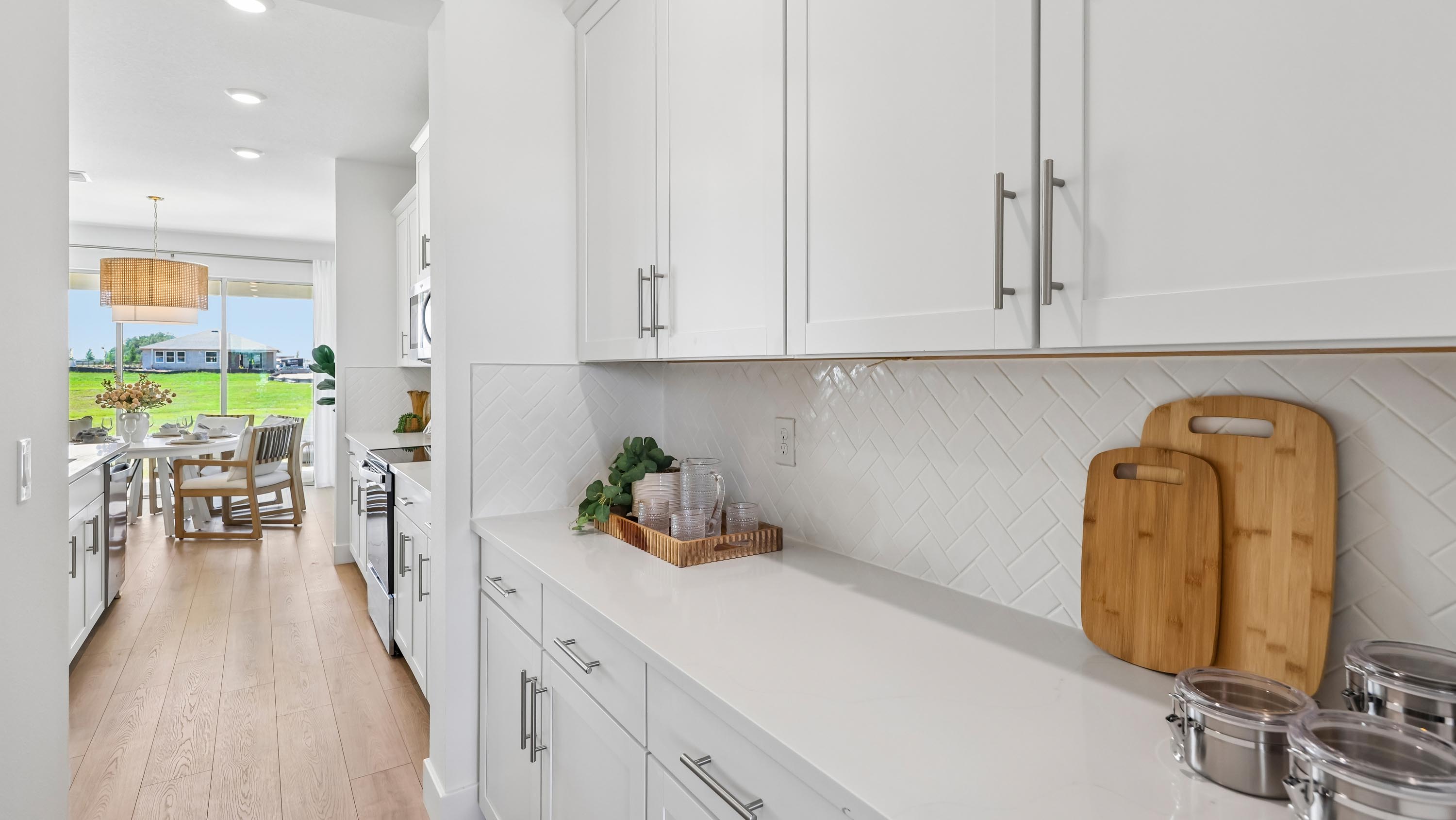 Holden walk-through pantry with cabinetry and countertops